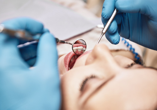 Dentist examining patients teeth in clinic