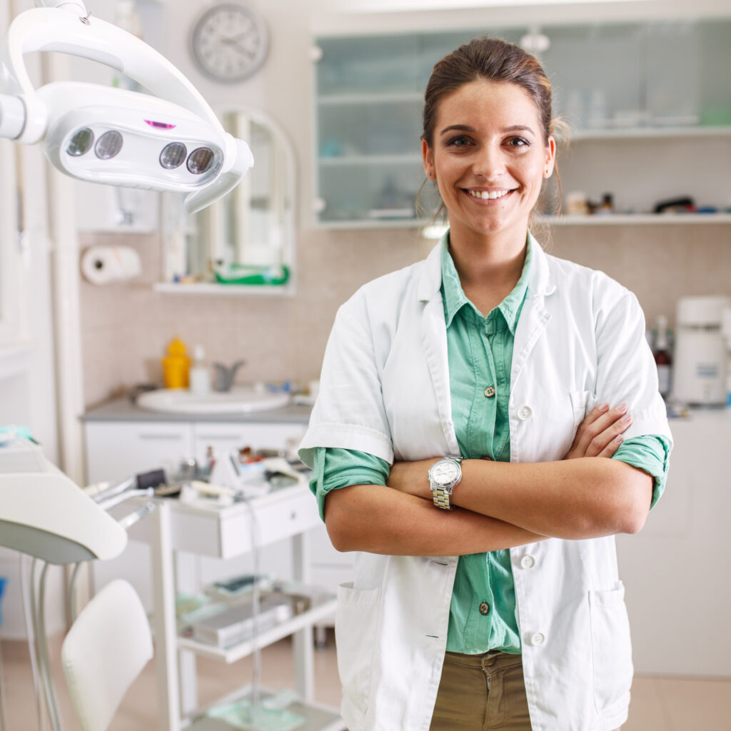 Portrait of female dentist .She standing in her dentist office.